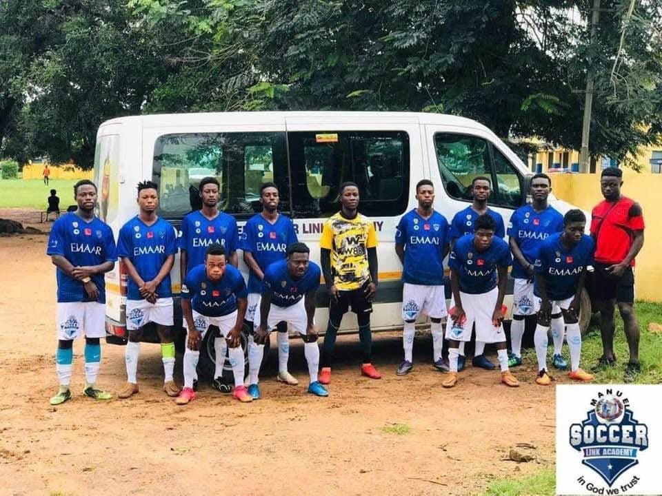 Players in blue kit standing in front of the academy's minibus before travelling to a match